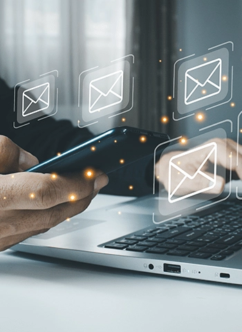 Email icons on computer and phone
