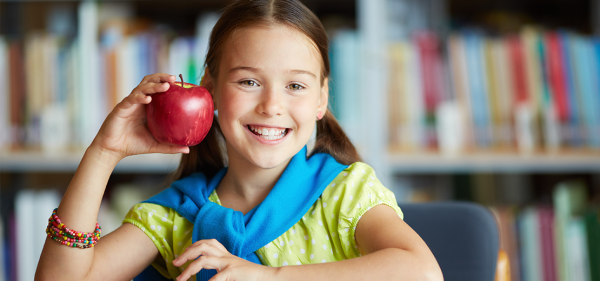 Girl student holding red apple